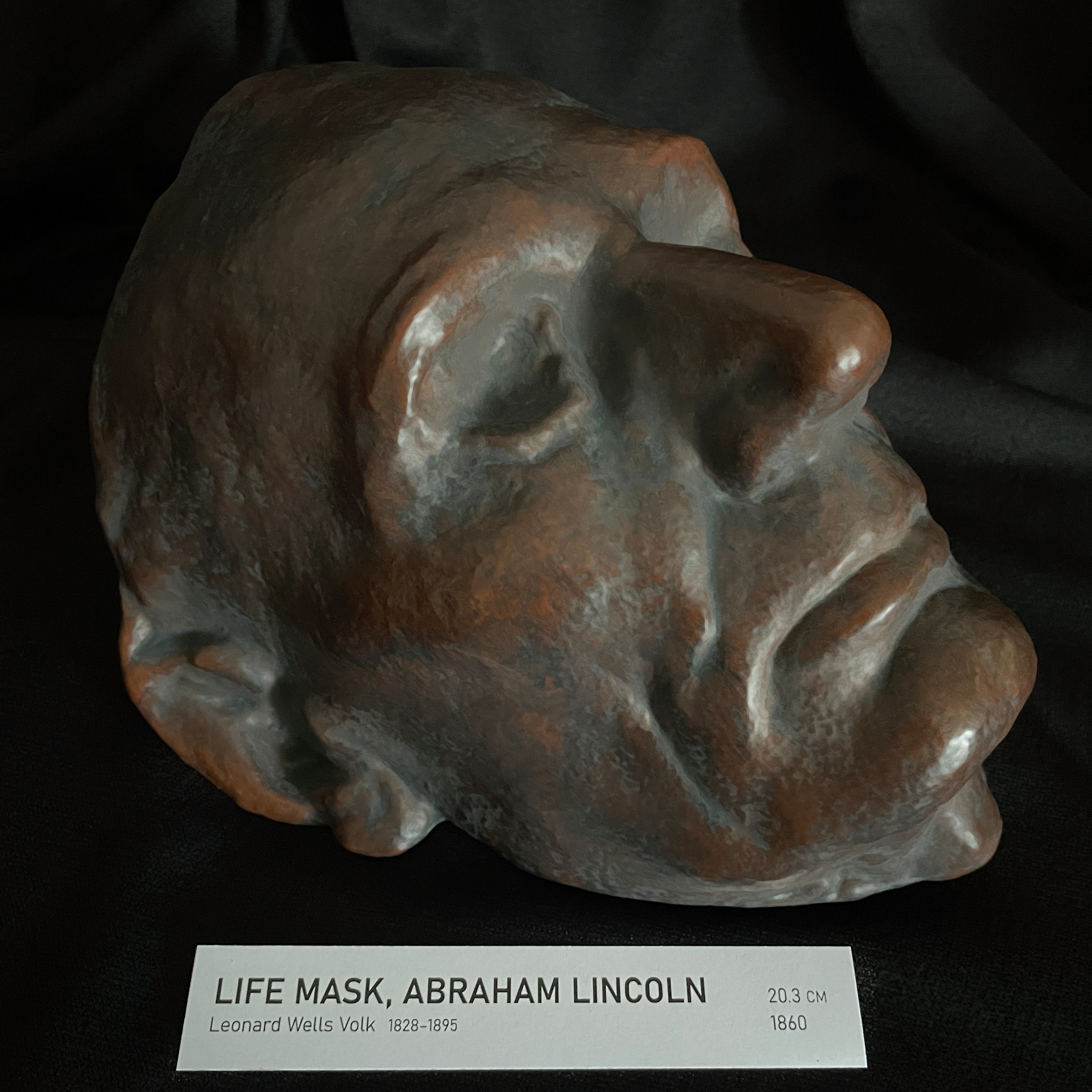 Left profile view of the 1860 Abraham Lincoln life mask replica with museum display tag.