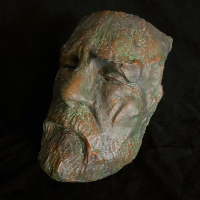 Detailed angled view highlighting the damaged facial features and torch-cut edges.
