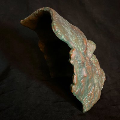 Elevated side perspective showing the hollow, concave structure of the face.